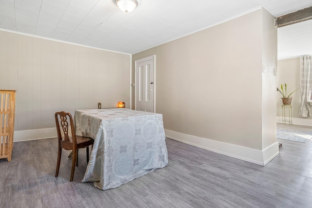 dining space with crown molding and dark hardwood / wood-style flooring