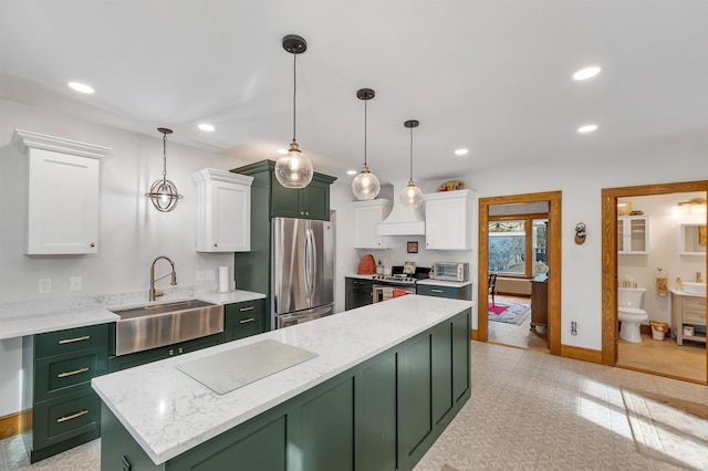 kitchen featuring pendant lighting, sink, green cabinetry, appliances with stainless steel finishes, and white cabinetry