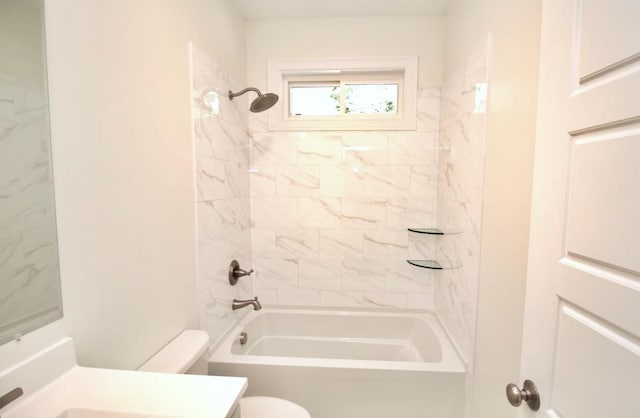 full bathroom featuring vanity, tiled shower / bath combo, and toilet