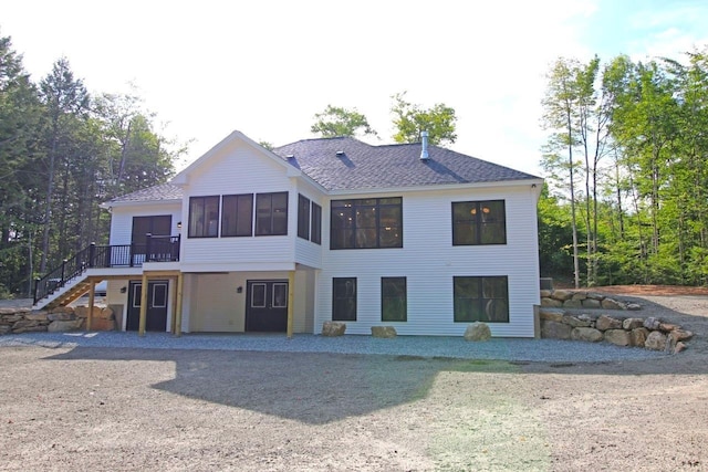 back of property with a sunroom