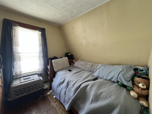 bedroom with dark hardwood / wood-style flooring