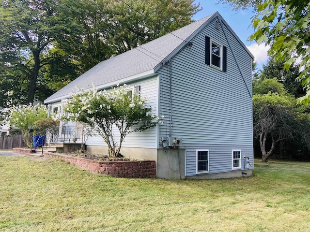 view of property exterior featuring a lawn