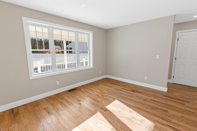 unfurnished room with light hardwood / wood-style flooring