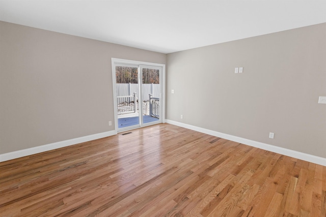 empty room with light hardwood / wood-style floors