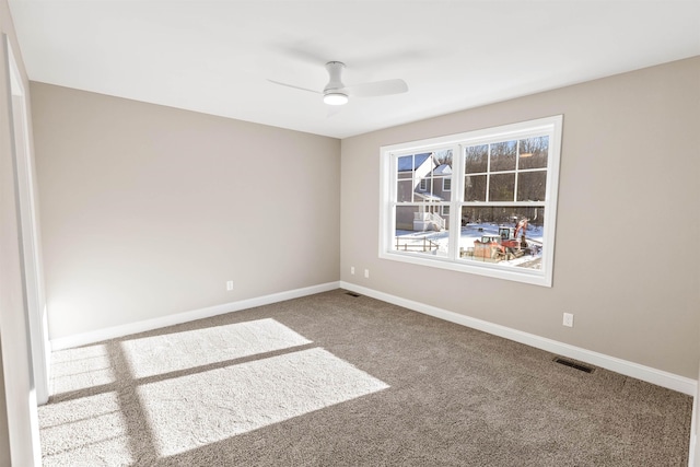 carpeted spare room featuring ceiling fan