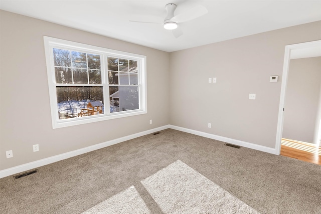 carpeted empty room featuring ceiling fan