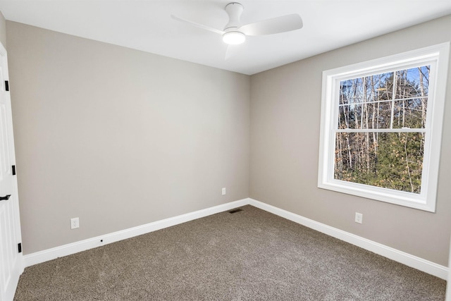 empty room featuring carpet flooring and ceiling fan