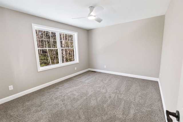 carpeted spare room with ceiling fan