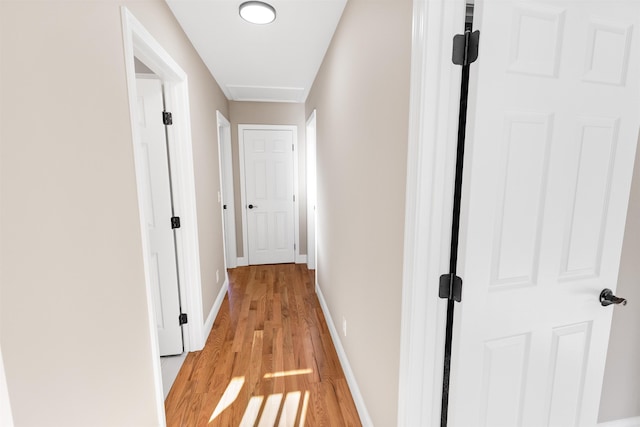 hallway with light hardwood / wood-style floors