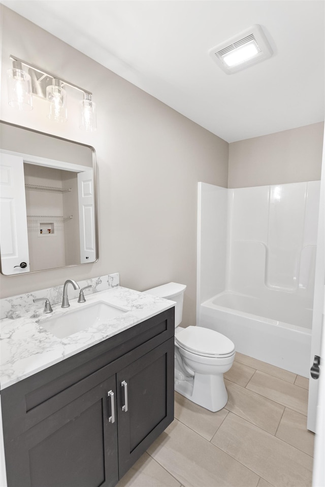 full bathroom featuring vanity,  shower combination, and toilet