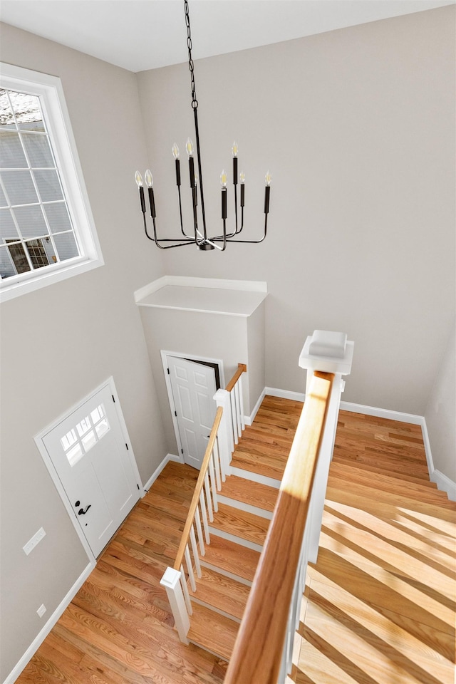 entrance foyer with light hardwood / wood-style flooring and a chandelier