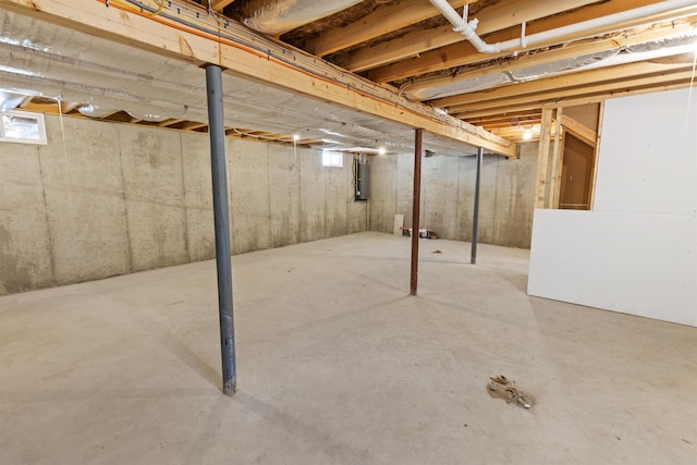 basement featuring a healthy amount of sunlight and electric panel