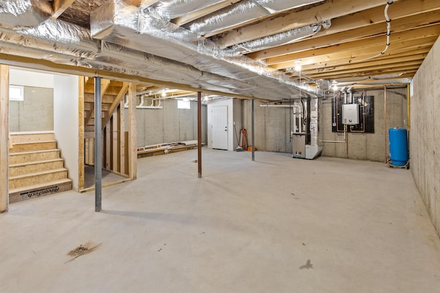 basement with tankless water heater and heating unit