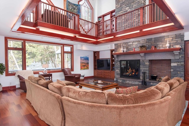 51 E Ash Rd, Plymouth, VT 05056 - living room featuring hardwood / wood-style floors, a towering ceiling, and a stone fireplace
