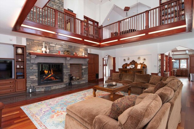 51 E Ash Rd, Plymouth, VT 05056 - living room with wood-type flooring, a towering ceiling, and a stone fireplace