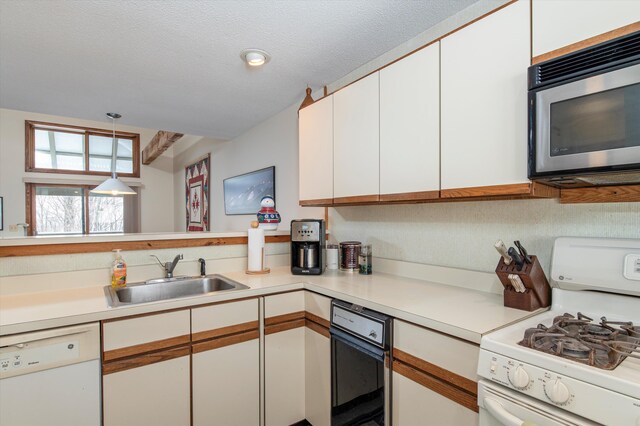 360 Okemo Trailside Ext Unit 37C, Ludlow, VT 05149 - kitchen with white appliances, white cabinetry, light countertops, and pendant lighting