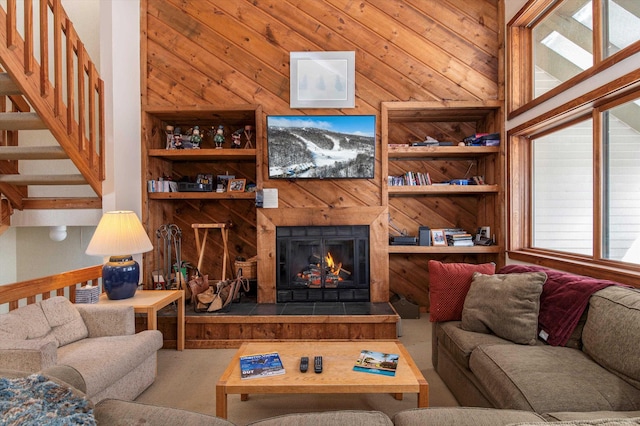 360 Okemo Trailside Ext Unit 37C, Ludlow, VT 05149 - living room featuring a lit fireplace, carpet flooring, built in shelves, and wooden walls