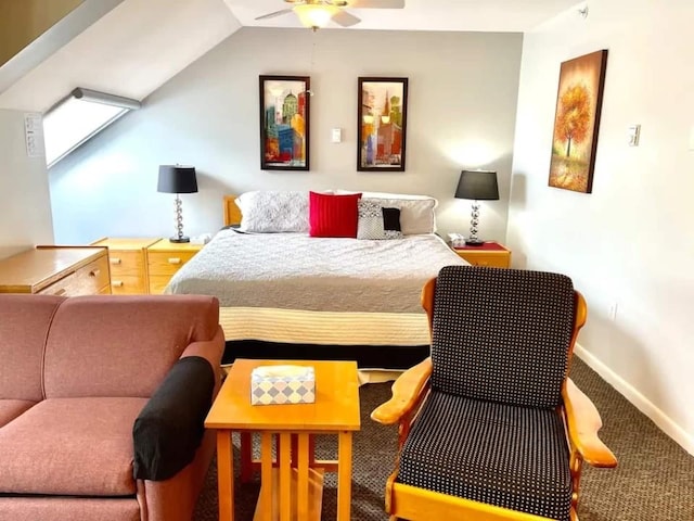 carpeted bedroom with ceiling fan and vaulted ceiling