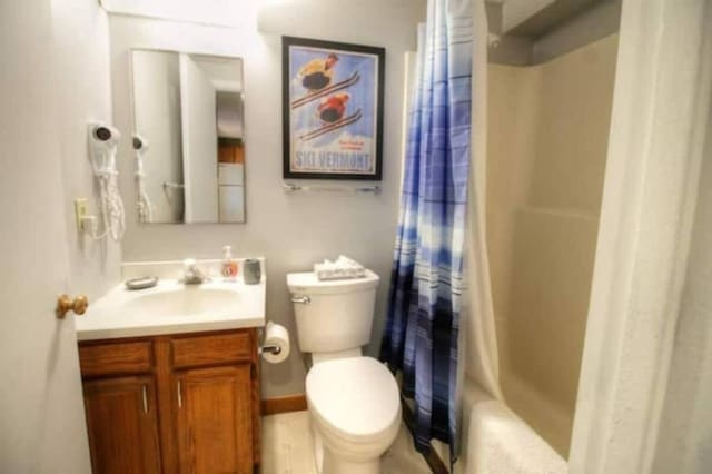 full bathroom with vanity, toilet, and shower / tub combo with curtain