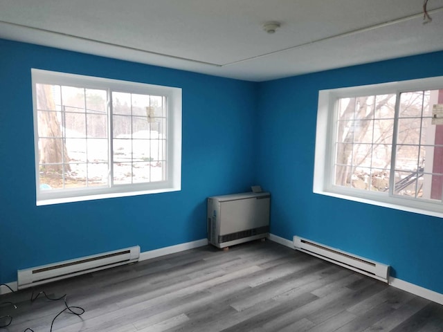 empty room with a baseboard radiator and wood-type flooring