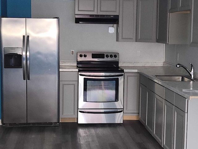 kitchen featuring gray cabinetry, stainless steel appliances, exhaust hood, sink, and dark hardwood / wood-style floors