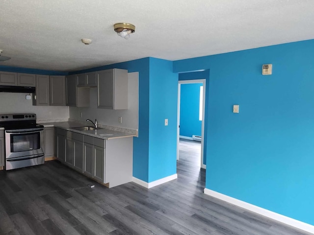 kitchen featuring stainless steel electric range, sink, gray cabinetry, and dark wood-type flooring