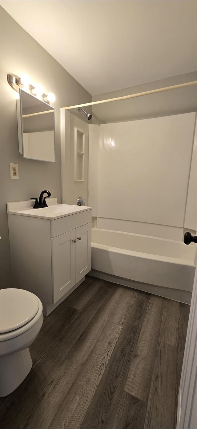 full bathroom with hardwood / wood-style flooring, vanity, and shower / bath combination