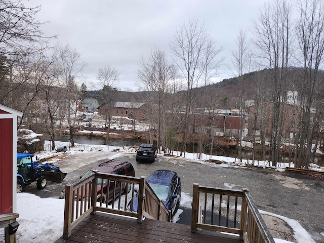 snow covered deck with a mountain view