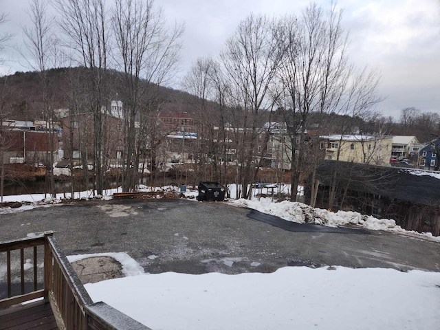 yard covered in snow with a mountain view