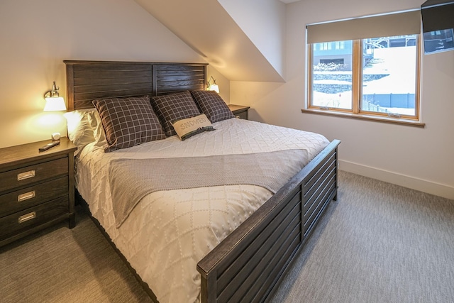 bedroom featuring vaulted ceiling and carpet