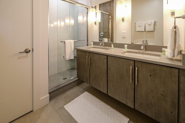 bathroom with vanity, a shower with door, and tile patterned floors