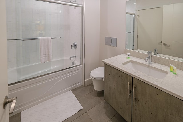 full bathroom featuring tile patterned flooring, vanity, shower / bath combination with glass door, and toilet