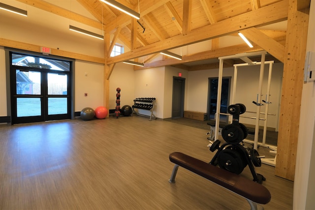 exercise room with wood-type flooring, wood ceiling, high vaulted ceiling, and french doors