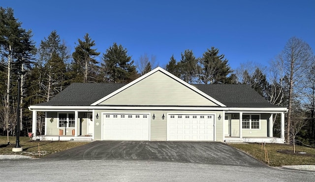 view of front property featuring a porch and a garage