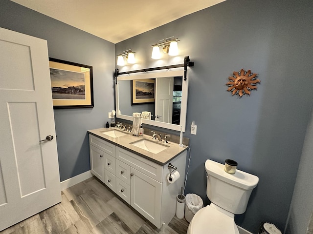 bathroom featuring hardwood / wood-style flooring, vanity, and toilet