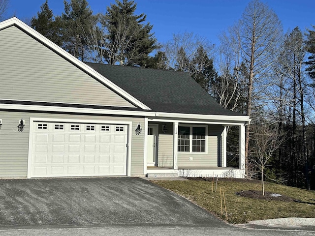 view of front facade featuring covered porch and a garage