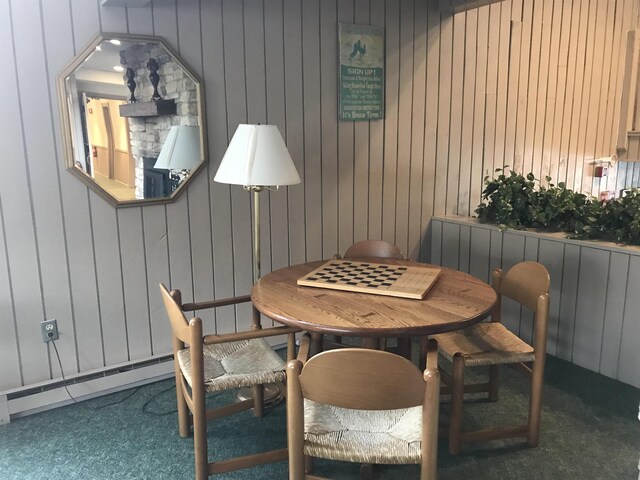 carpeted dining area featuring radiator heating unit and baseboard heating