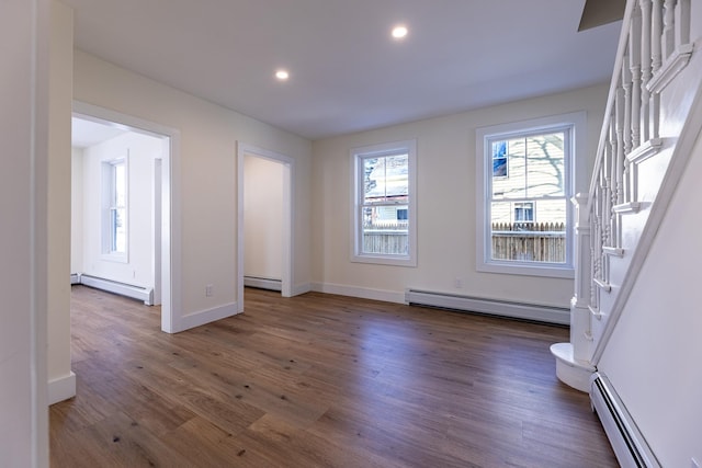 interior space featuring dark wood-type flooring and a baseboard heating unit