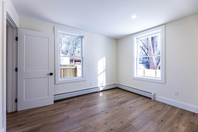 empty room featuring plenty of natural light and hardwood / wood-style floors