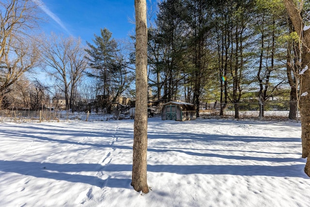 snowy yard featuring an outdoor structure