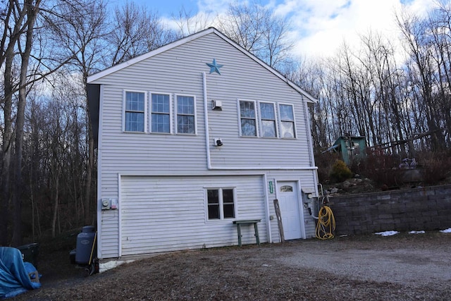 rear view of property featuring a garage