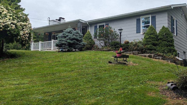 exterior space with a yard and a chimney