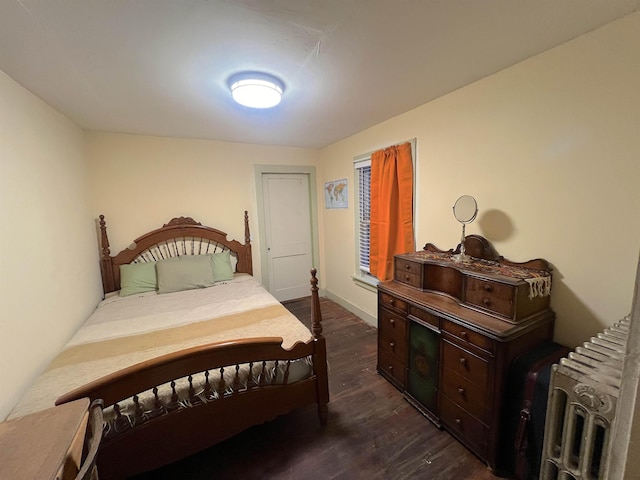 bedroom with dark wood-type flooring