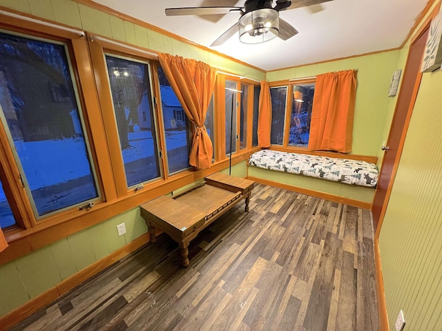 sitting room featuring ceiling fan, dark wood-type flooring, and ornamental molding