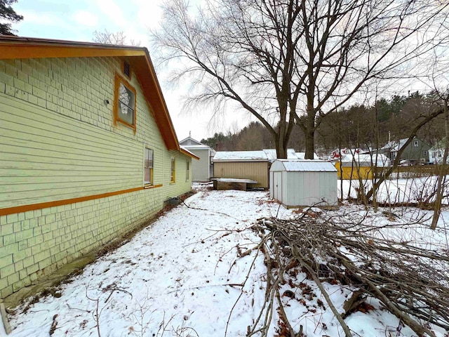 snowy yard with a storage unit