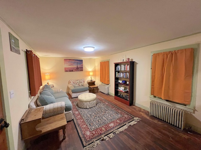 living room featuring radiator heating unit and dark wood-type flooring