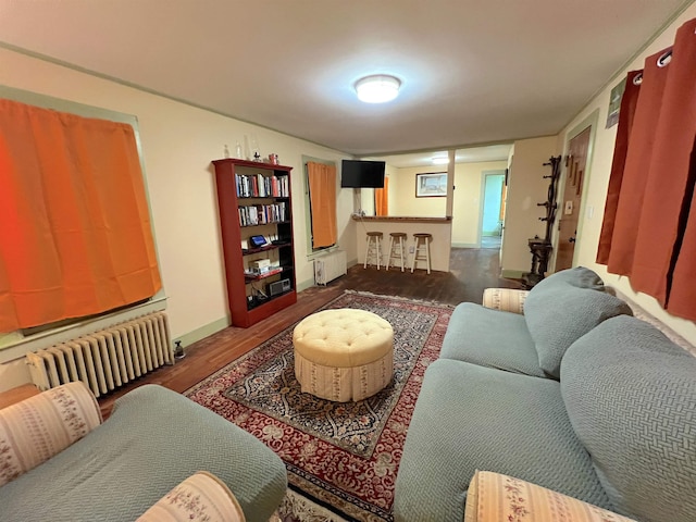 living room featuring radiator heating unit and dark hardwood / wood-style floors