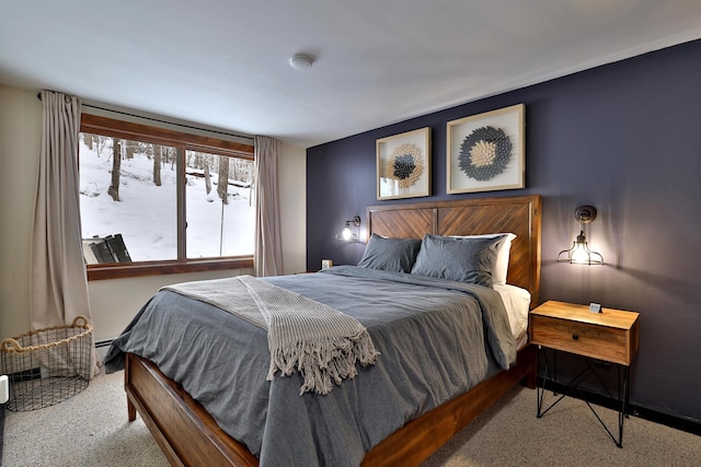 carpeted bedroom with a baseboard radiator