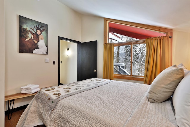 bedroom featuring wood-type flooring and lofted ceiling