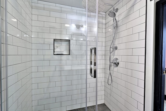 bathroom featuring a shower with door